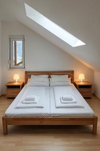 a bedroom with a large bed with two night stands at Lakeview Apartment in Ostriach