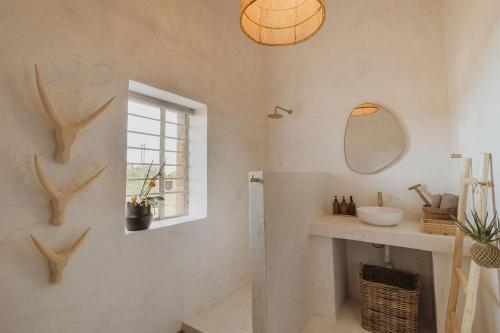 a bathroom with a sink and a mirror on the wall at Waterval Guest Farm in Bloemfontein