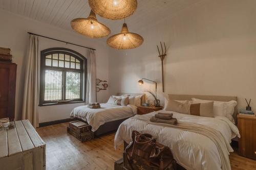 a bedroom with two beds and a window at Waterval Guest Farm in Bloemfontein