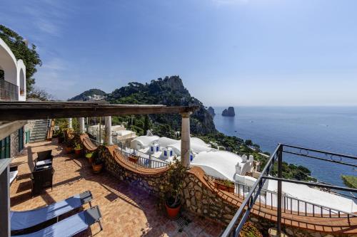 a resort balcony with a view of the ocean at Essence One by Sweet Capri in Capri