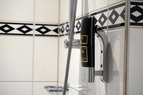 a blow dryer in a shower in a bathroom at Westlake Hotels Amsterdam in Amsterdam