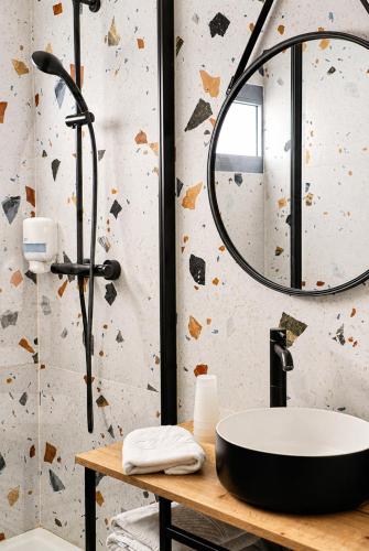 a bathroom with a sink and a mirror at Sud Hôtel Restaurant in Bastia