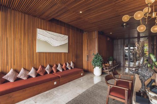 a living room with a couch with pillows on it at Sana Vie Villa Seminyak by Ini Vie Hospitality in Seminyak