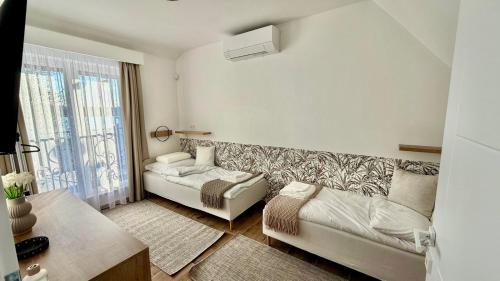 a living room with a couch and a window at TJ Nyaraló in Markaz