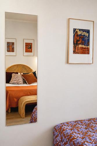 a bedroom with a bed and a mirror on the wall at Sud Hôtel Restaurant in Bastia