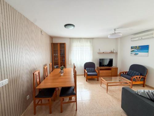 a living room with a table and chairs and a couch at Respiro di Levante in Oropesa del Mar