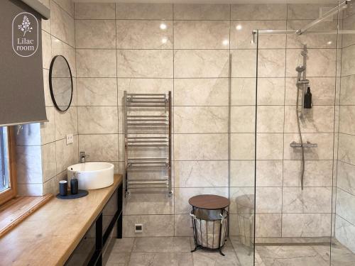 a bathroom with a shower and a sink at Lilac room in Ozolnieki