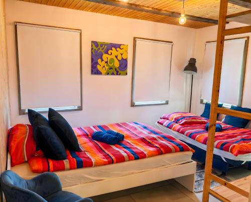 a bedroom with two bunk beds and a ladder at Blaue Wohnung - Goldenes-Häusle in Sulzbach an der Murr