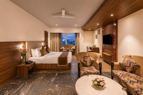 a hotel room with a bed and a couch at Hotel Royal Aravali in Udaipur