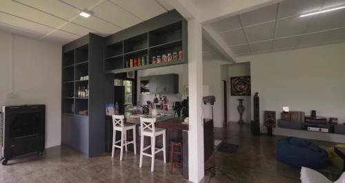 a bar in a room with two stools in a room at DuriDuri Eco Resort in Bentong
