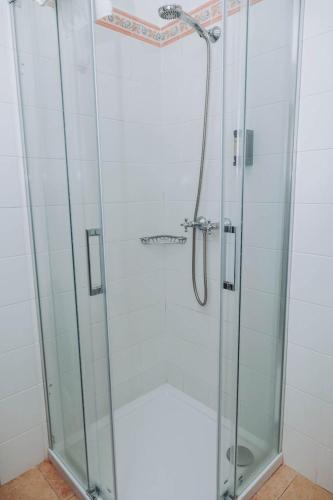 a shower with a glass door in a bathroom at Casa Veiga Rooms in Valdoviño