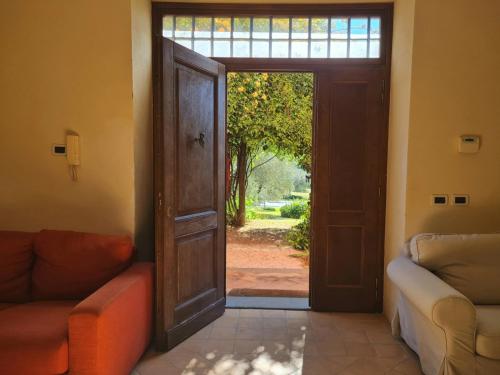 an open door leading to a living room with two couches at Villa Flavia in Manziana