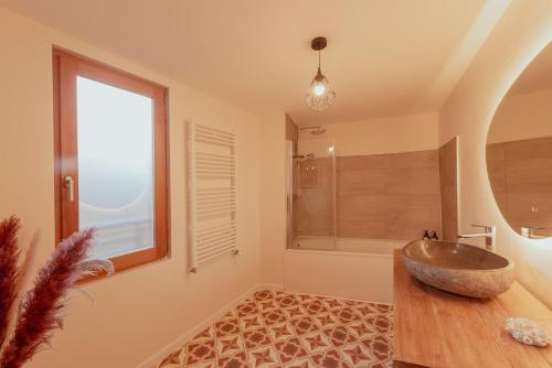a bathroom with a sink and a large window at Maison POHESY in Figeac