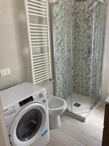 a bathroom with a washing machine and a toilet at SeaYouSoverato Apartment in Soverato Marina