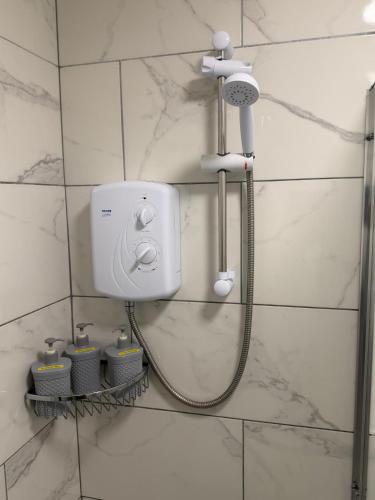 a shower in a bathroom with a shower head at The Parade, Market Square room 3 in Northampton