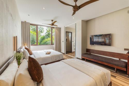 a bedroom with two beds and a couch at Zen Valley Dalat in Da Lat
