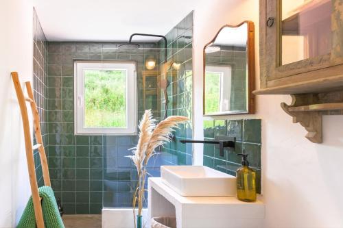 a bathroom with a sink and a mirror at Cozy Countryside Studio in Aldeia do Cano