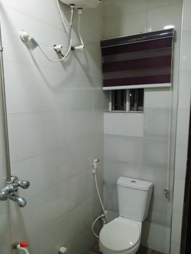 a small bathroom with a toilet and a shower at OUR HILLs HOTELs AND SUITES in Ekoro