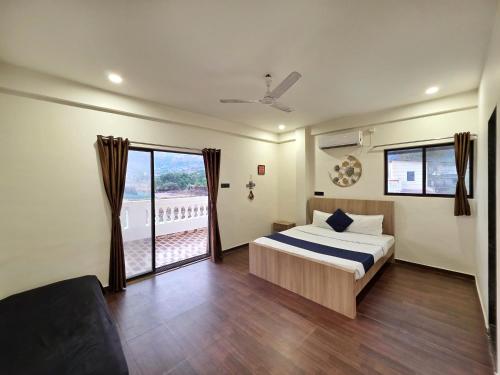 a bedroom with a bed and a large window at JAGUAR VILLA II 3BHK II AC II POOL Il EMPYREAN STAY in Lonavala
