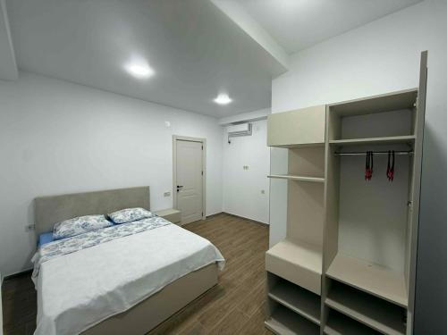 a bedroom with a bed and a closet at Grigoleti Royal in Grigoleti