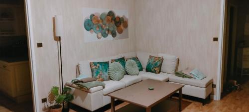 a living room with a white couch and a table at Marmande in Marmande