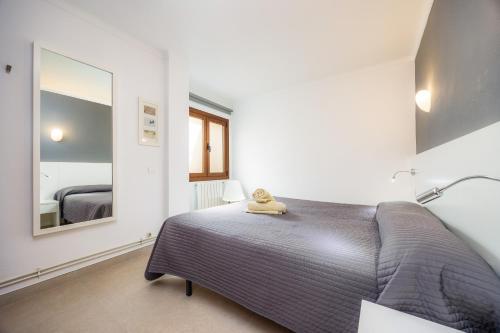 a bedroom with a bed and a large mirror at Cala Figuera Apartment 1b in Cala Figuera