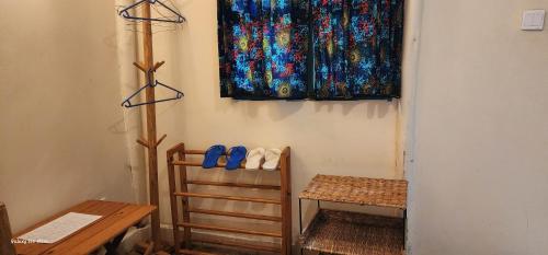 a pair of shoes sitting on a chair in a room at Kizumba House in Arusha