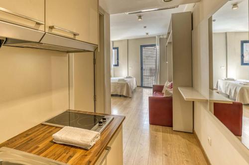 a kitchen with a sink and a stove in a room at Aparthotel 1904 in Figueres