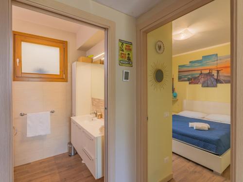 a small bathroom with a bed and a sink at EnjoyIseoLake - Blooming Lakefront in Fonteno