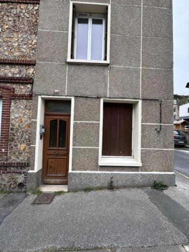 a brick building with a door and two windows at Gîte Le Central - Port & Plage in Fécamp