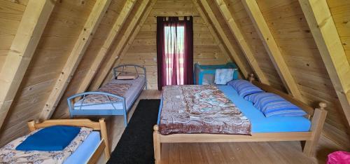 a room with two beds in a log cabin at Wooden Fairytale in Bihać