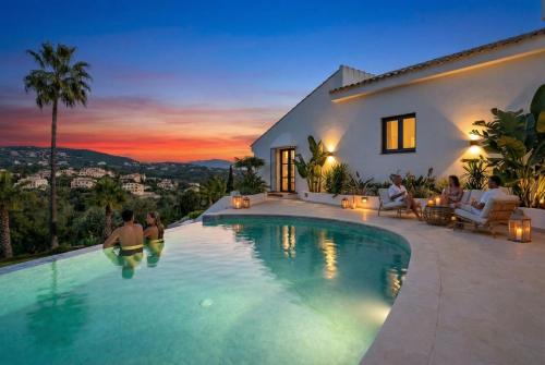 a villa with a swimming pool at night at Villa Kahuna Sotogrande in Sotogrande