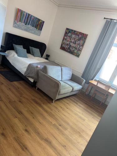 a living room with a bed and a couch at Elfenvilla in Erkelenz