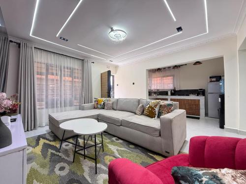 a living room with a couch and a table at Gono Retreat Four bedroom in Kisumu