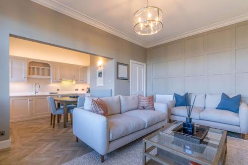 a living room with a couch and a table at 20 Golf Place in St. Andrews