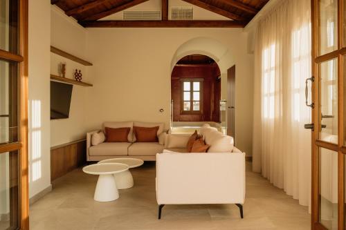 a living room with a couch and a table at Galetso Studios by Still Collection in Nikiti
