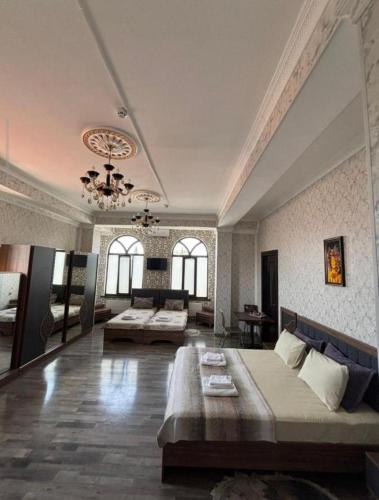 a large room with two beds and a couch at Delfin Hotel Restaurant Spa Ailevi in Ganja