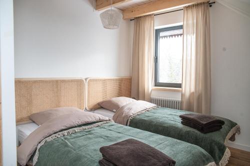 two beds sitting next to each other in a bedroom at Tropianka - sielski dom na skraju wsi in Tropie