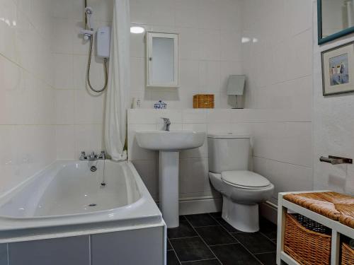 a white bathroom with a sink and a toilet at 2 Bed in Blaenau Ffestiniog oc-86064 in Maentwrog