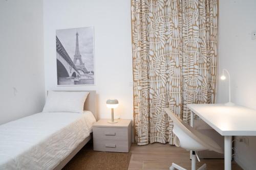 a small bedroom with a bed and a desk at The Castle Apartment in Brescia