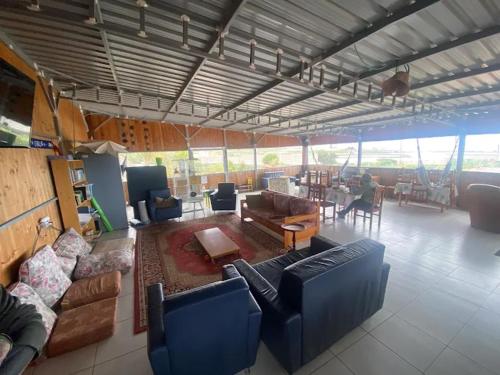 a large living room with couches and a table at Agrocamping Invernaderito in Tejina