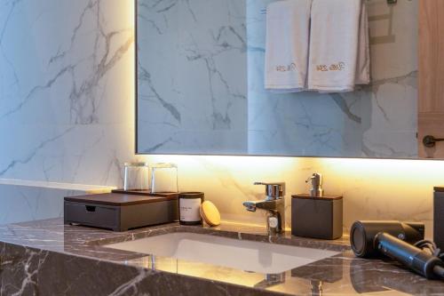 a bathroom counter with a sink and a mirror at Villa 234 Yogyakarta in Yogyakarta