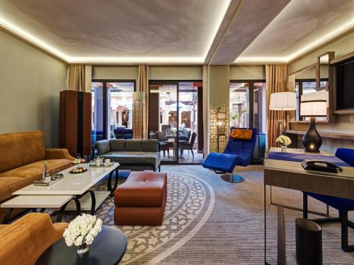 a living room with a couch and a table at Mövenpick Hotel Mansour Eddahbi Marrakech in Marrakech