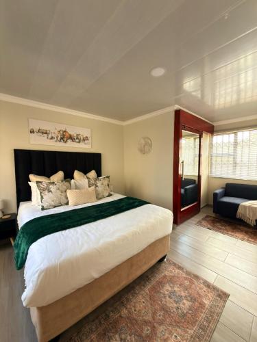 a bedroom with a large bed and a couch at Iyana Lodge in Grasmere
