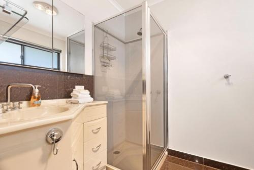 a bathroom with a shower and a sink at Maffra Retreat in Maffra
