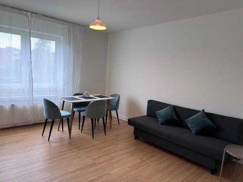 a living room with a couch and a table and chairs at CityZen Apartment CpH in Copenhagen