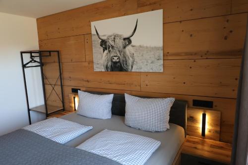 a bedroom with a bed with a picture of a bull at Ferienapartment Horn in Altendorf
