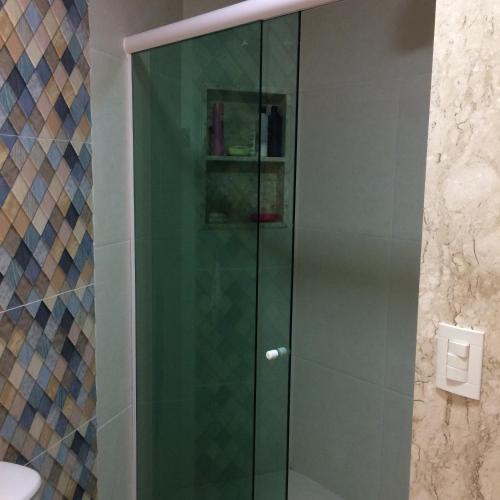 a shower with a glass door in a bathroom at Flat Carneiros Beach Resort in Tamandaré