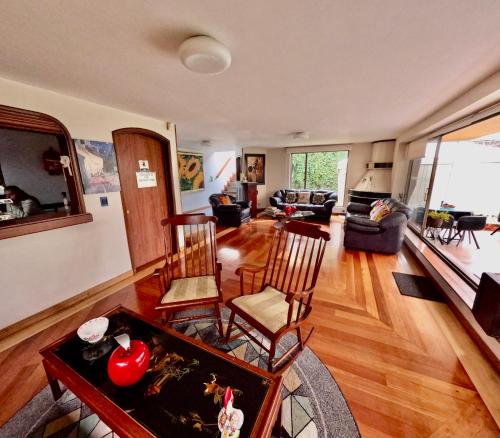 a living room with a couch and a table and chairs at Hotel Casa Iris in Chía