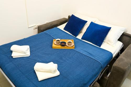 a bed with a tray of food on top of it at Studio Mare Kotor in Dobrota